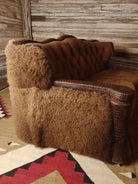 Buffalo hide and leather tufted loveseat side detail - Your Western Decor