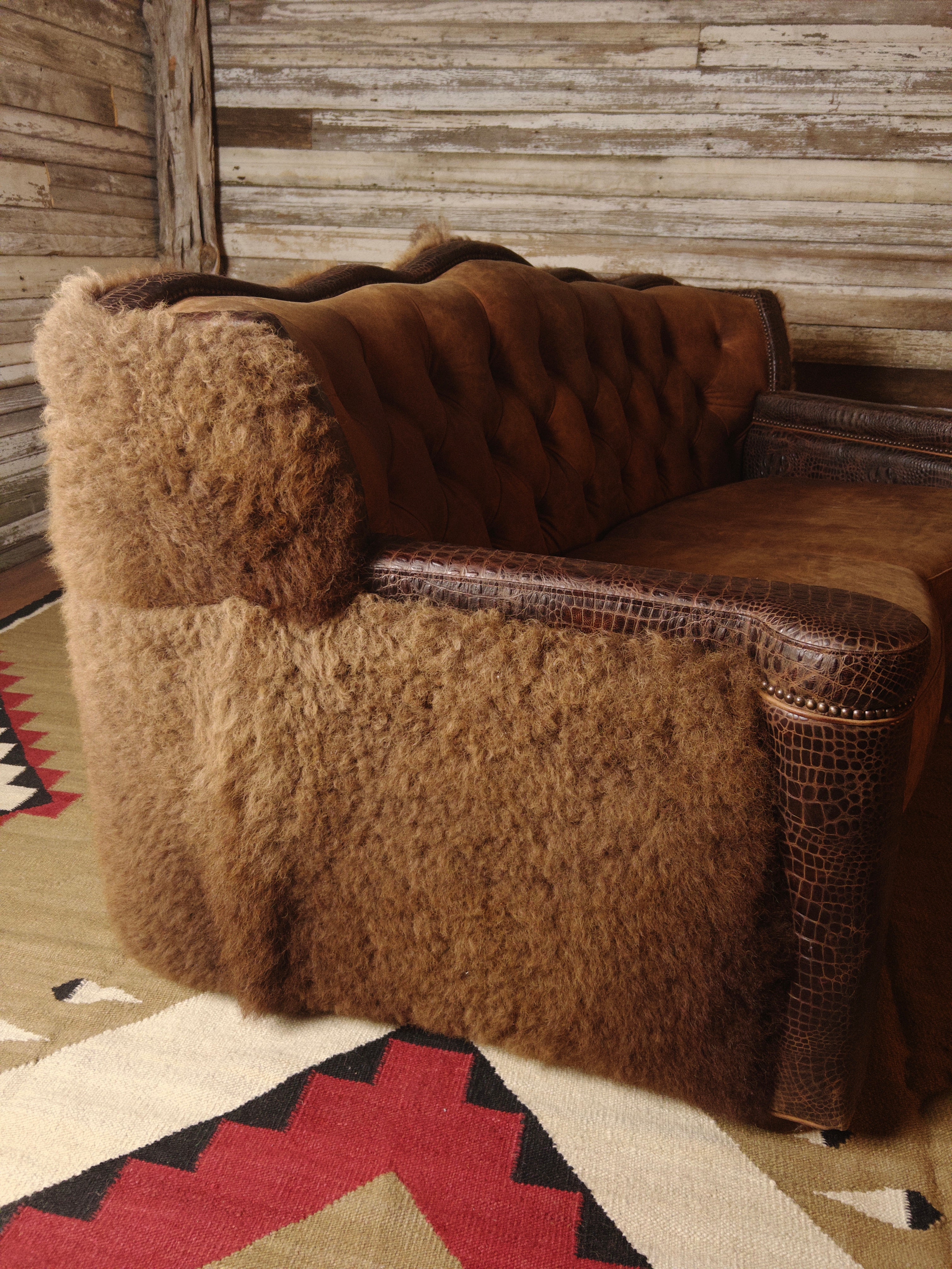 Buffalo hide and leather tufted loveseat side detail - Your Western Decor