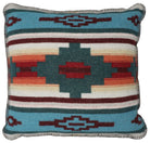 A square woven throw pillow featuring a Southwestern geometric pattern in turquoise, dark teal, rust red, orange, cream, and dark brown, finished with a fringed edge. Handmade in the USA