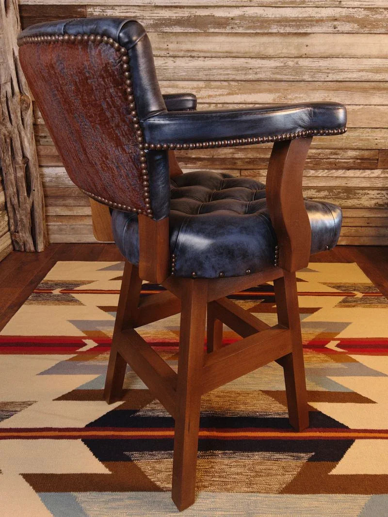 Hand tufted blue leather swivel bar stool with antiqued nailhead trim and hardwood frame
