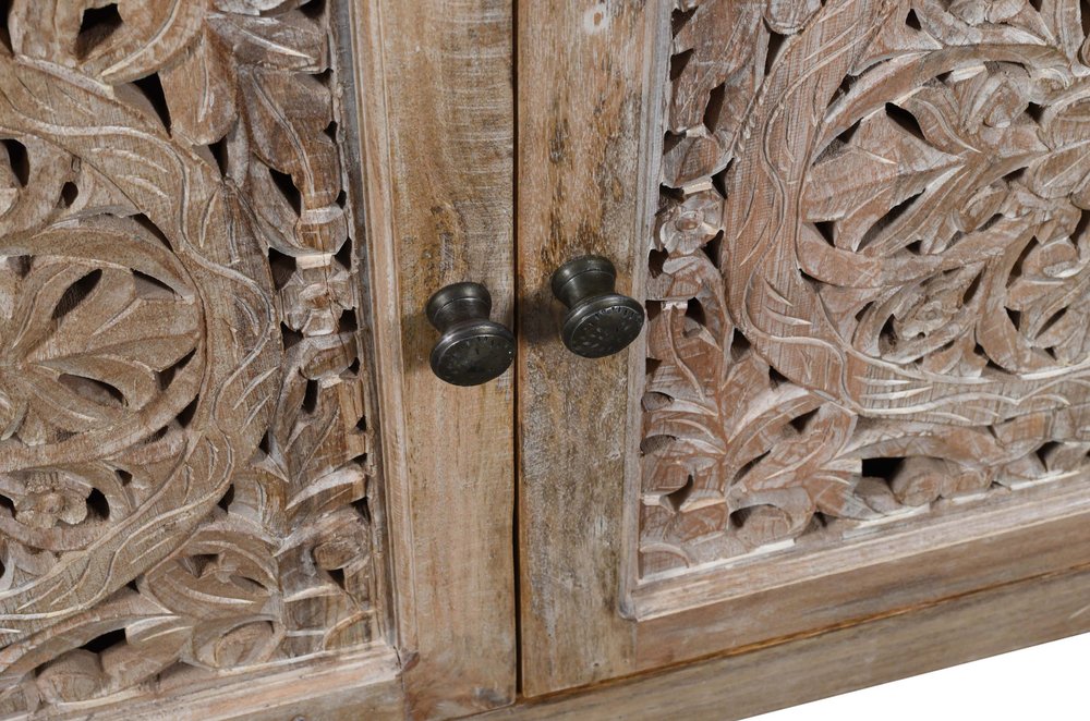 Detail of hand carvings on mango wood sideboard 
