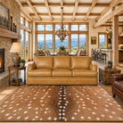 Camel color Canyon Crest Leather Sofa with Axis print area rug and antler chandelier 