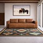 Canyon Saddle Modern Western leather sofa in pure aniline brown leather with clean track arms, wide seat, and dark wood block feet, shown in a modern ranch living room with Southwestern area rug and framed horse artwork.