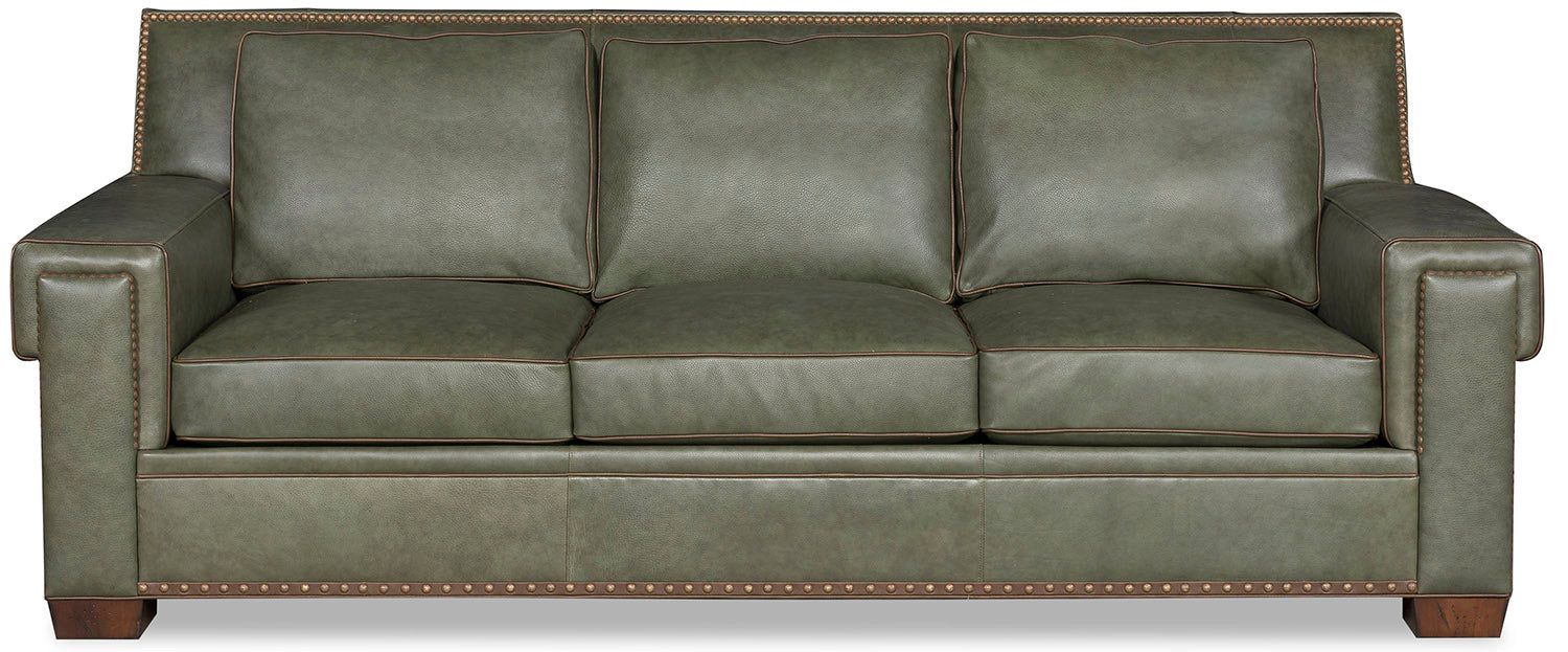 Front view of green leather sofa with optional gimp, brown welt, and nail trim
