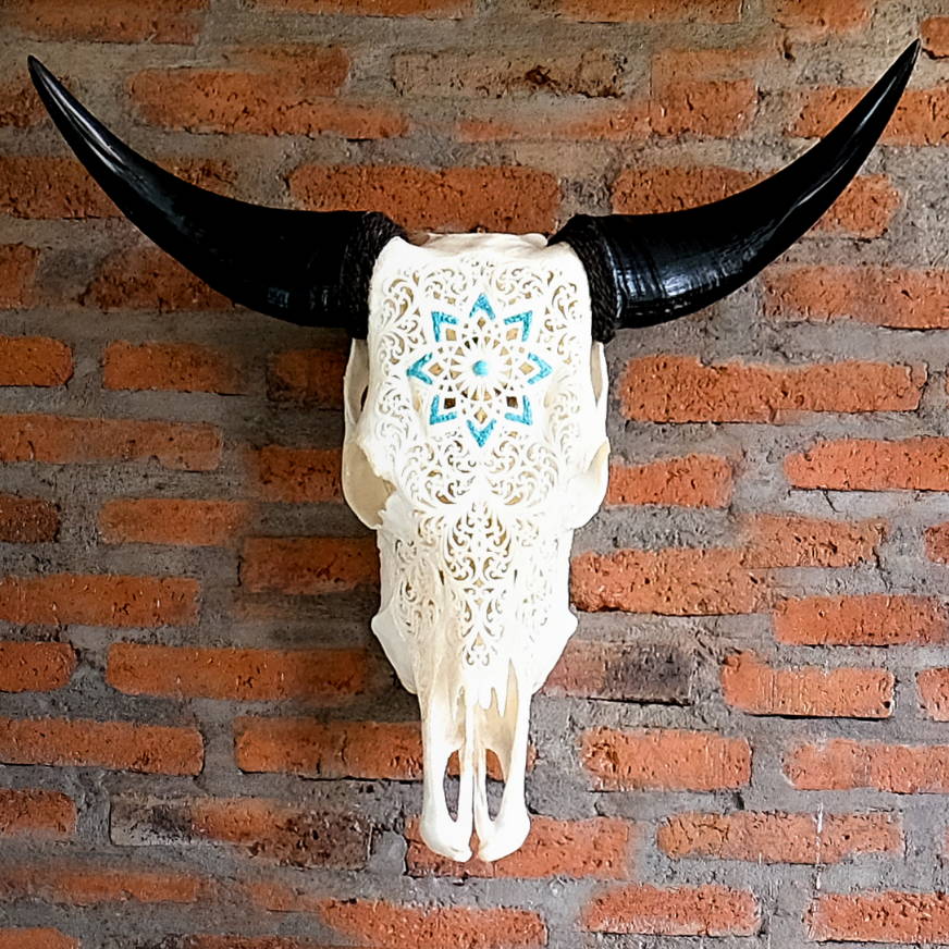 Carved steer skull mounted on rustic brick wall - Your Western Decor