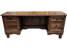 A rustic dark brown wooden writing desk with a twisted rope trim along the top edge, featuring two drawers on each side and turned wooden feet.