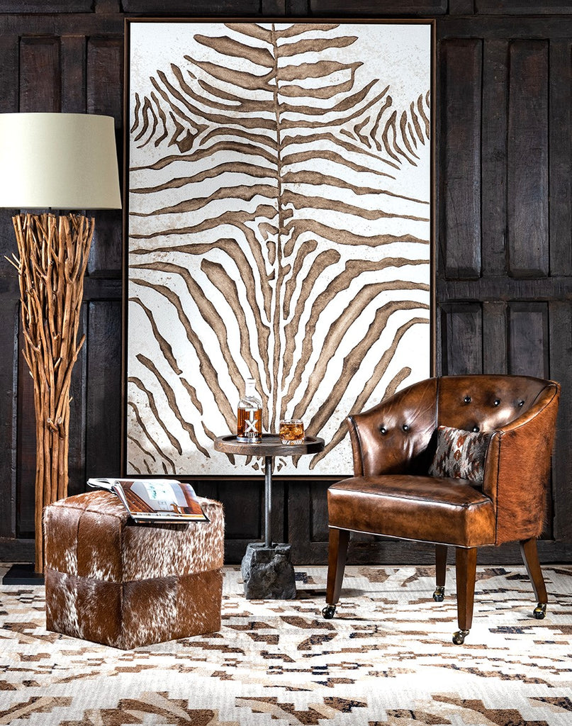 Cattle club chair with curio zebra rug and cowhide cube ottoman - Your Western Decor