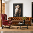 Rustic luxury leather Chesterfield sofa staged in modern ranch living room with warm western decor