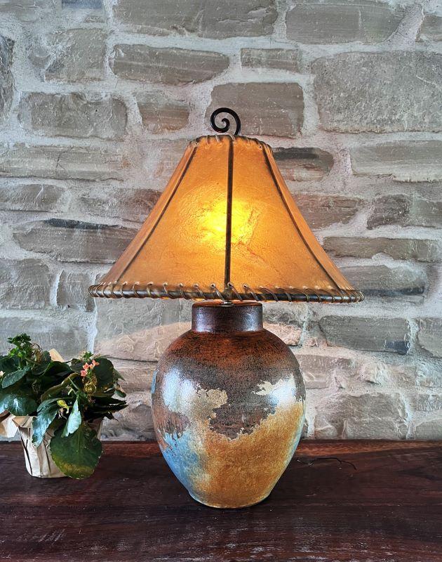 Decorative lamp with a warm glow against a stone wall - Your Western Decor