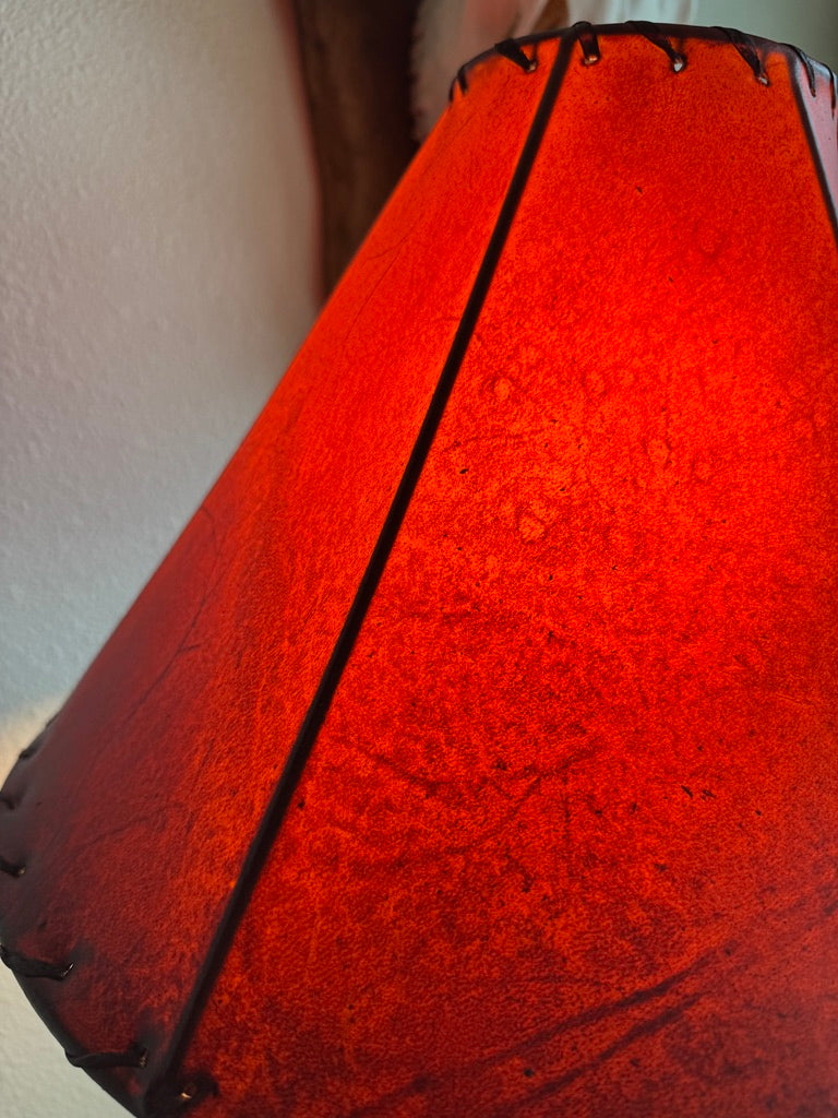 Close up of amber rawhide lamp shade with light on 