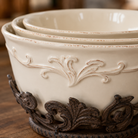Close-up of embossed acanthus scroll border on cream stoneware bowl.