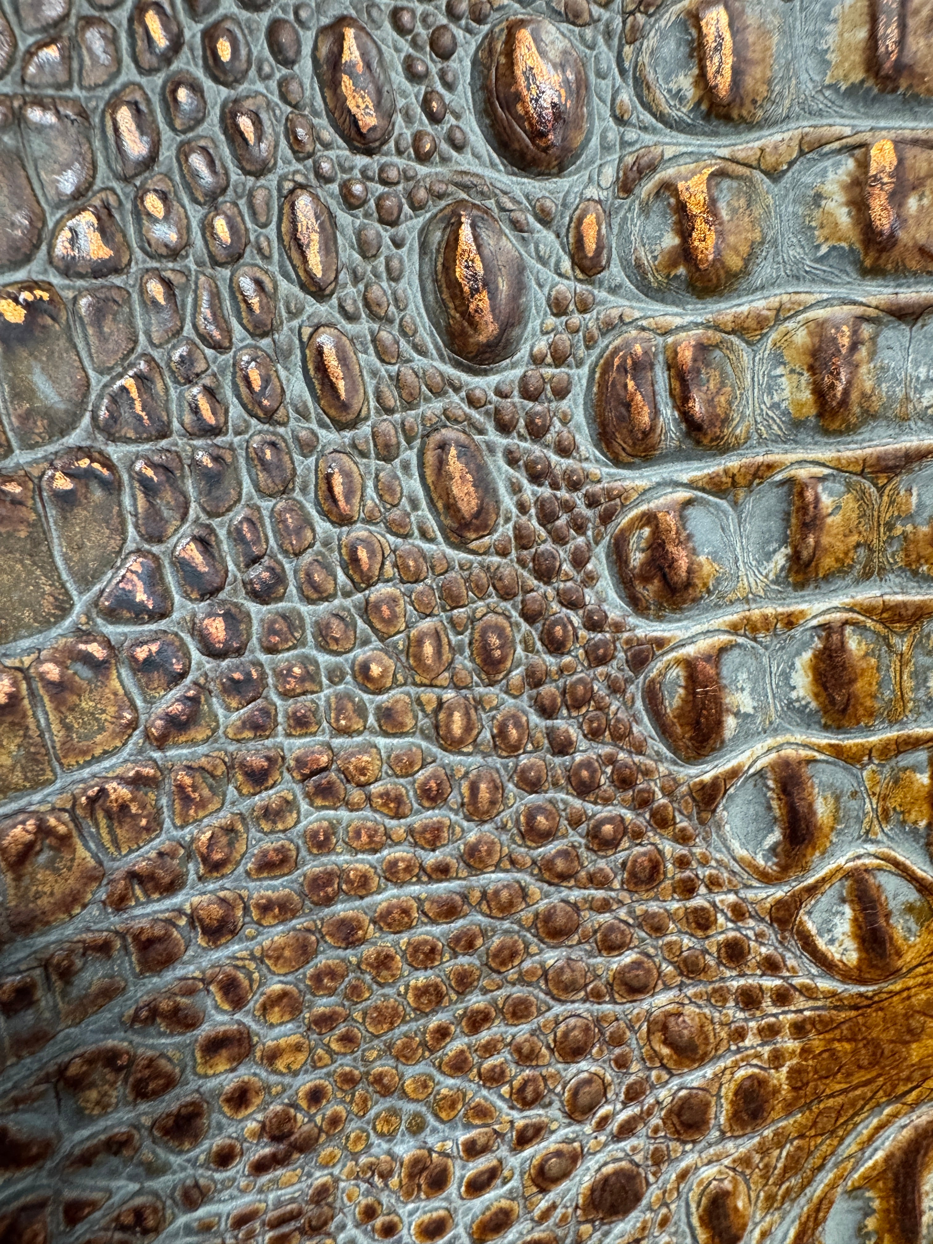 Close up detail of Midas Touch brown, grey and metallic croc embossed leather