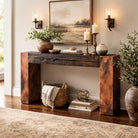 Wooden console table with copper legs and decorative items in a living room setting