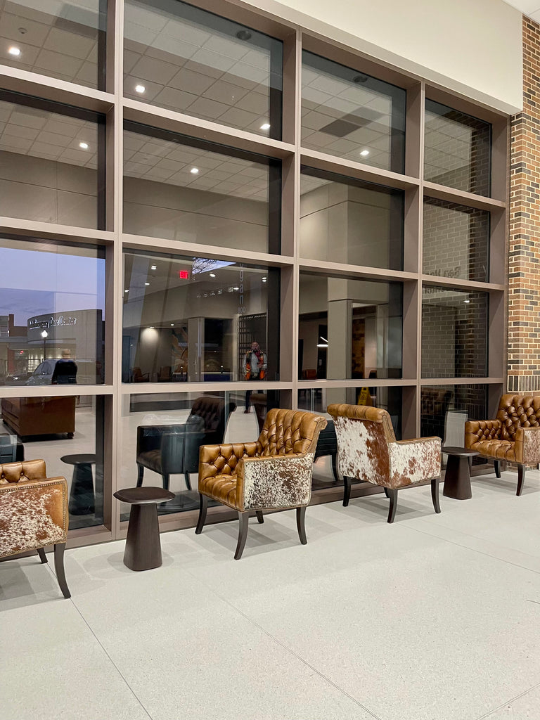 Cowhide and leather tufted chairs in hospital waiting area - Your Western Decor