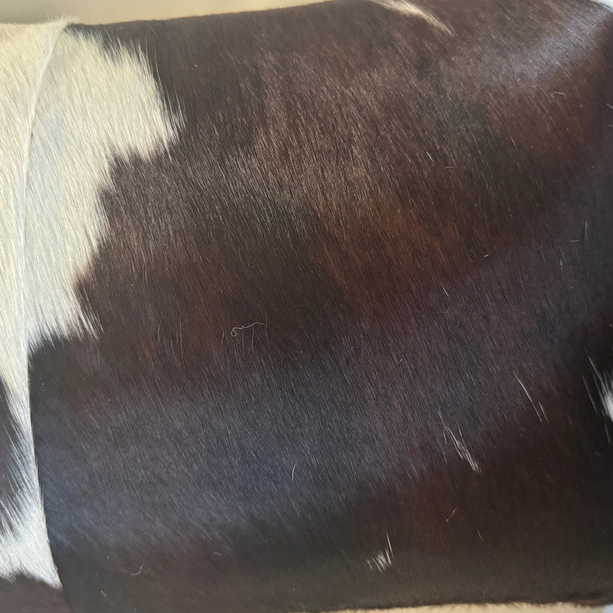 Chocolate and white cowhide pillow detail 