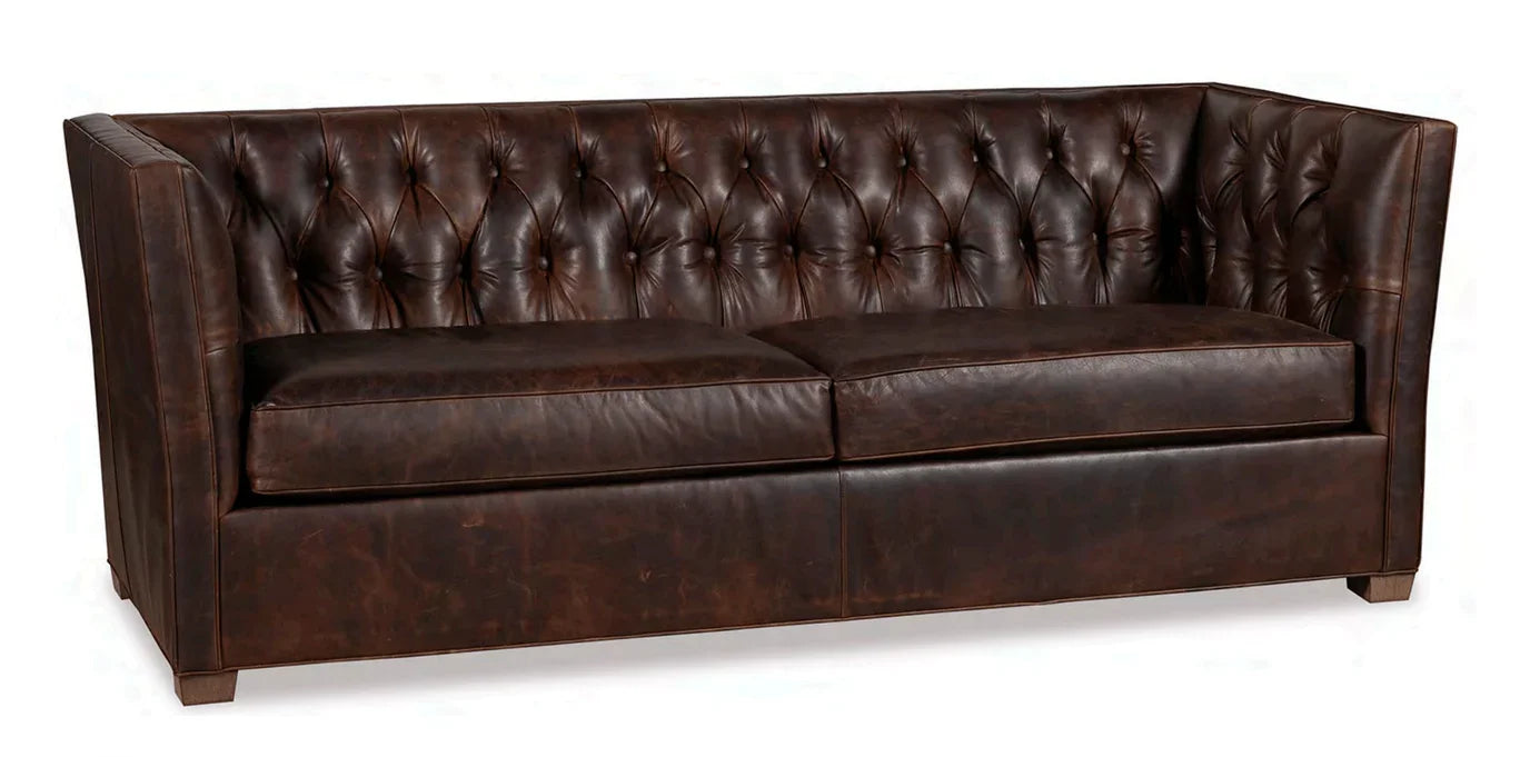 Brown leather sofa with tufted backrest on a white background - Your Western Decor