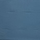 A close-up of a textured blue fabric surface with subtle horizontal stitched seams.
