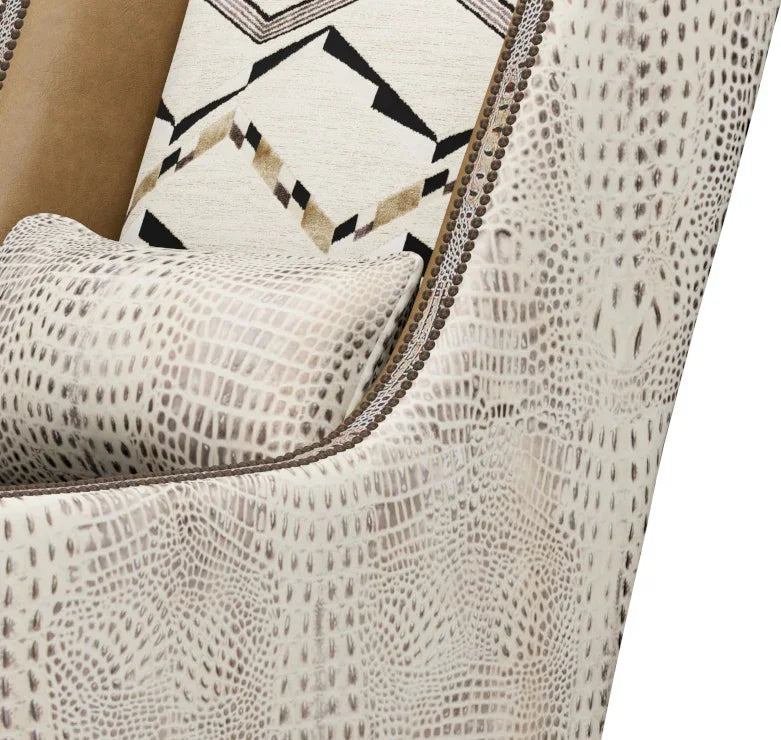 Close-up of a textured armchair with patterned cushions.