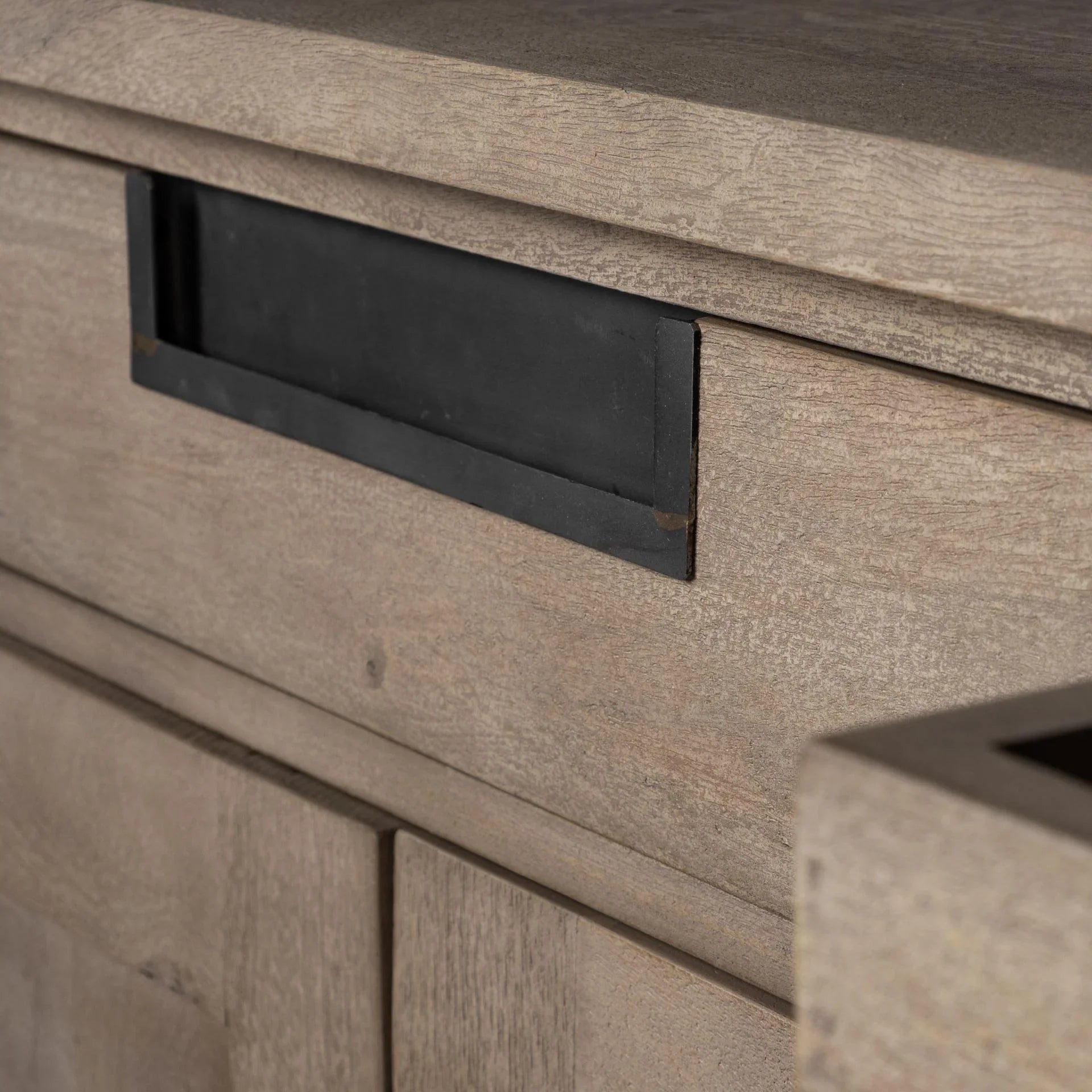 Detail of drawer hardware on mango wood sideboard