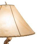mule deer antler table lamp with warm ambient lighting and natural rawhide lamp shade detail 