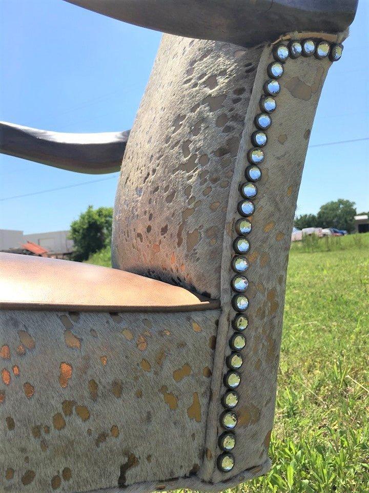 Detailed view of gold metallic cowhide and leather office chair with rhinestone detail trim