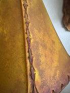 Close up of whip stitching detail on buckskin color rawhide lamp shade