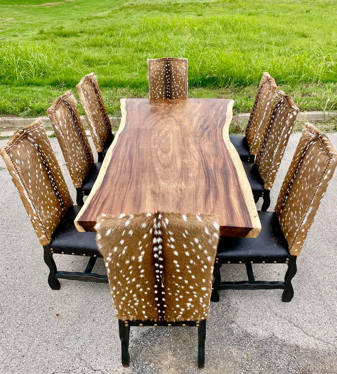 Wooden dining table with eight chairs featuring deer print patterns outdoors - Your Western Decor