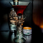 Cocktail in a decorative glass with elk base on a dark background - Your Western Decor