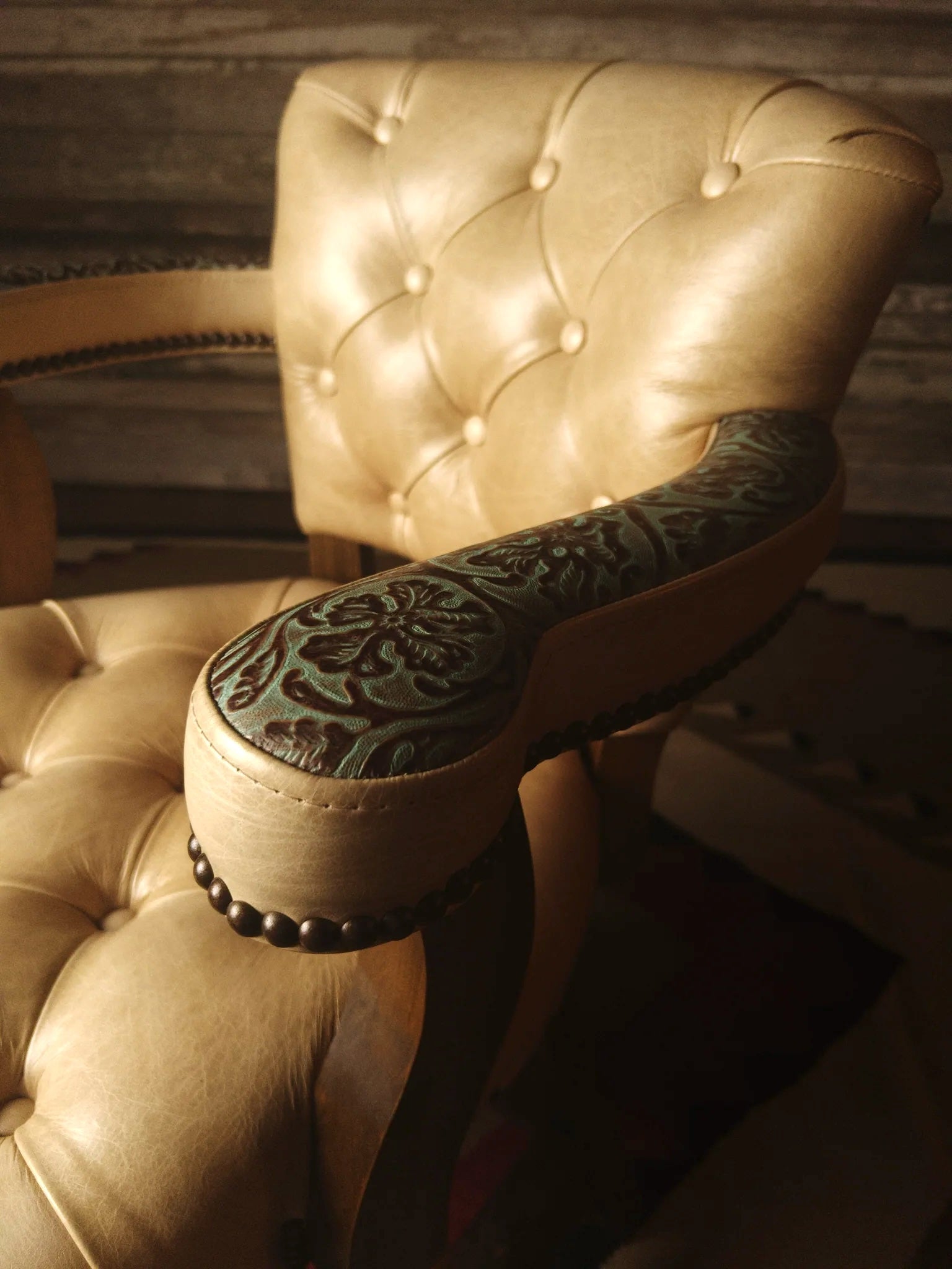 Floral embossed leather arm detail on tufted leather barstool - Your Western Decor