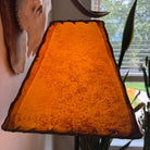 End view detail of rectangle rawhide lamp shade with natural viening with light on 