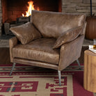 Brown leather armchair in a cozy living room with a fireplace and pumpkin - Your Western Decor