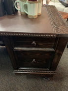 rustic western office desk with carved wood panels and leather writing surface in ranch workspace