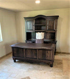 rustic western office desk, credenza, and hutch with carved wood panels and leather writing surface in ranch workspace