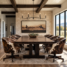 A rustic meeting room scene with a long dark wood table, several upholstered leather and leather conference chairs featuring cowhide-patterned outside. A large framed western-style artwork hangs on a stone wall, and large windows look out onto a landscape.