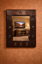 Decorative faux leather mirror with star designs on a textured wall - Your Western Decor