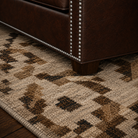 Close up of nail trim on dark brown leather sofa 