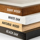 Stack of wooden boards with labels for different wood types and colors