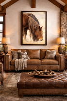 Wild Spirit framed wild horse canvas wall art displayed vertically above a leather sofa in a luxury western lodge living room with high wood beam ceilings