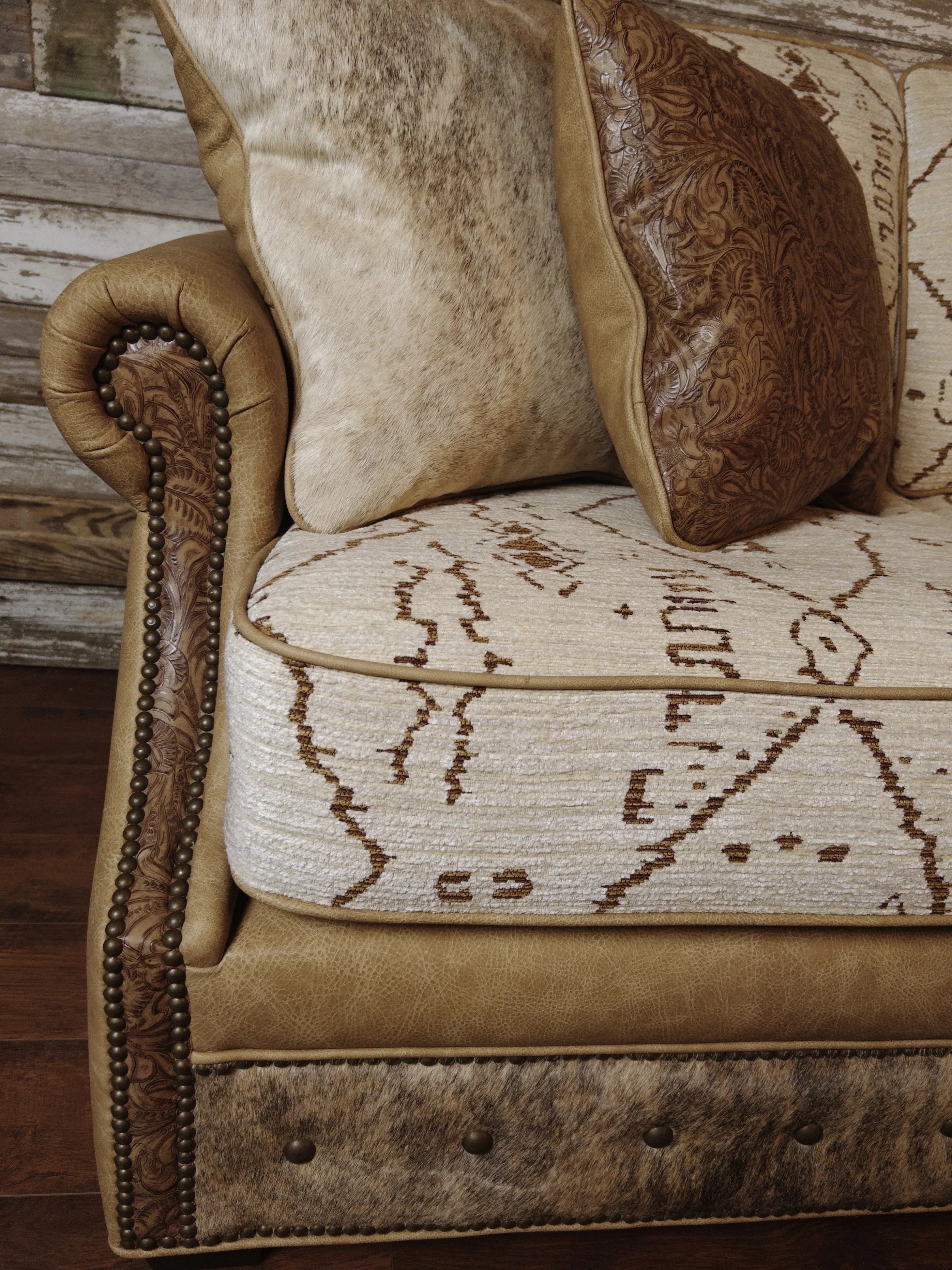 Close up of Mesa fabric and leather sofa with nail and cowhide trim 