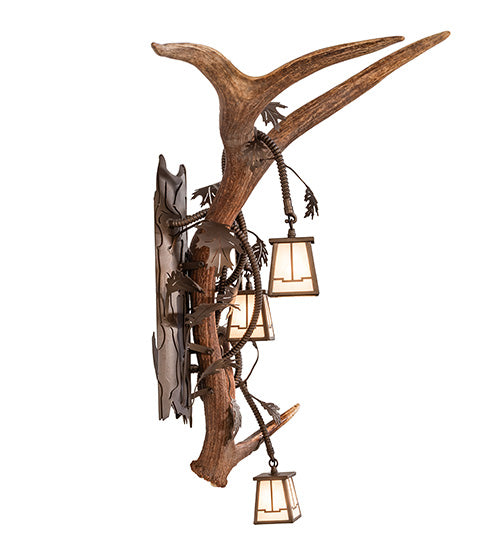Decorative wall sconce with antlers and lanterns on a white background