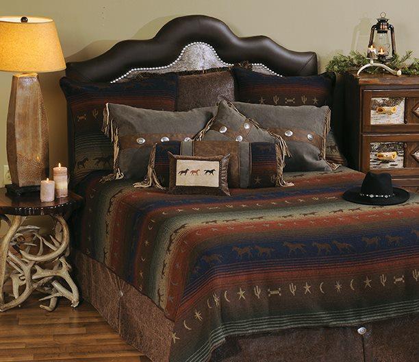 Bedroom with rustic decor featuring a bed with galloping trails bedding featuring running horses, pillows, antler table, and a lamp.