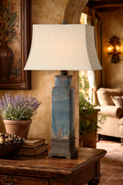 Decorative lamp with a textured base on a wooden table in a warm-toned room - Your Western Decor