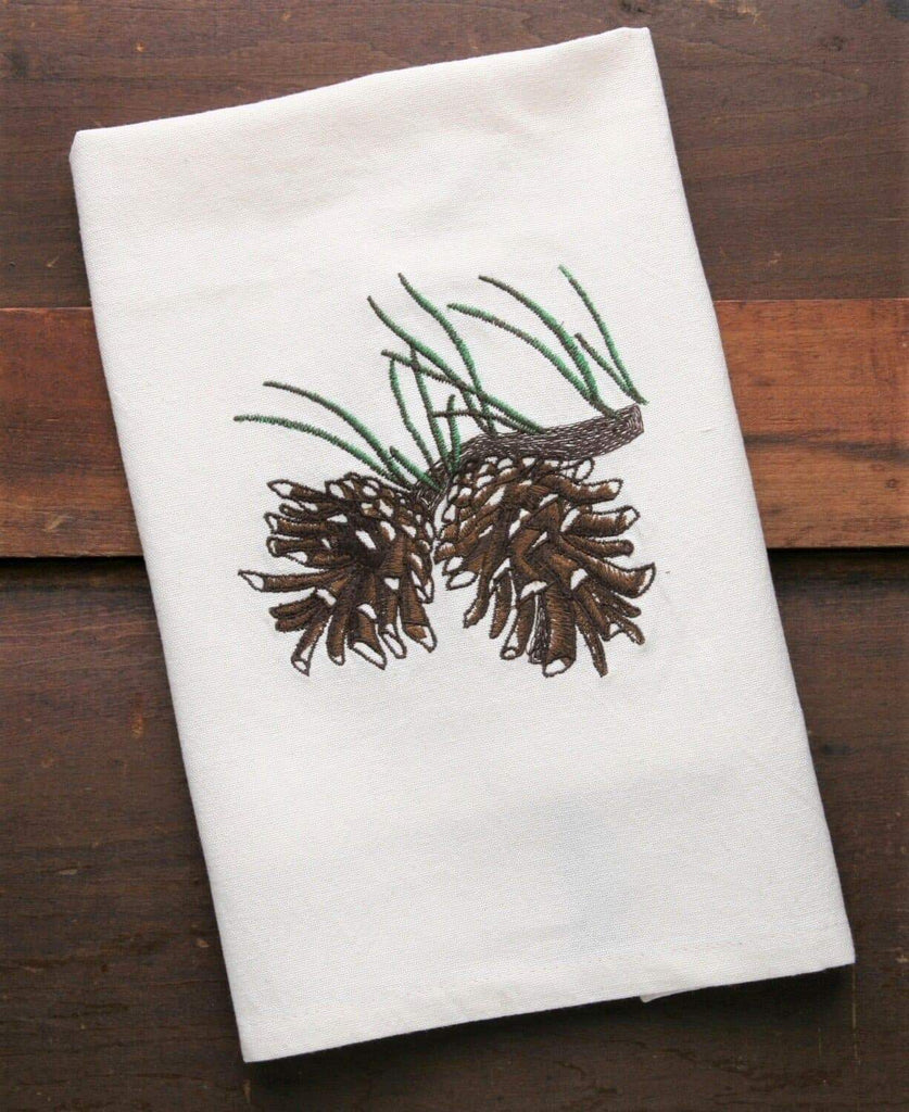 Ivory kitchen towels with embroidered pine cone design. Your Western Decor