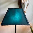 Illuminated teal rawhide rectangle lamp shade with handcrafted whip stitching