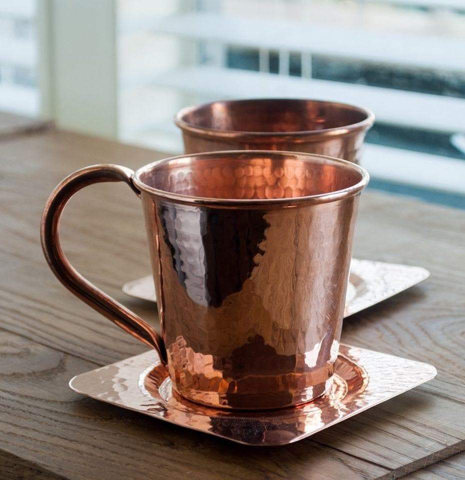 Hammered copper moscow mule mugs on copper coasters. Your Western Decor