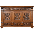An ornate carved wooden sideboard cabinet with three main doors, decorative scrollwork relief panels, fluted side columns, and round feet, shown on a plain white background.
