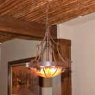 Hand-forged iron chandelier with handmade rawhide dome in western themed room 