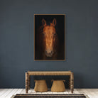 Framed portrait of a horse on a dark wall above a wooden console table with two stools - Your Western Decor