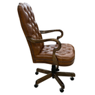 A brown tufted leather office chair with a dark wood five-star base and casters, shown from a three-quarter angle against a white background.