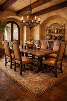 Dining room with wooden table and Leather Heritage Dining Chairs, rustic decor, and chandelier.